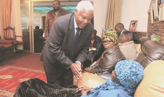 Defence Minister Dr Sydney Sekeramayi consoles Gogo Elizabeth Mumbengegwi — the mother to Dr Samuel Mumbengegwi who passed on on Monday — while Foreign Affairs Minister Simbarashe Mumbengegwi, brother to the deceased and other mourners look on in Harare yesterday. — (Picture by Munyaradzi Chamalimba)