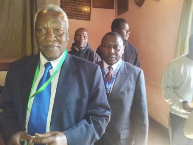 Cde Sekeramayi and Cde Kaukonde follow proceedings to cast their votes.