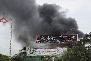 Devastation: Smoke rises from the roof top of the Westgate mall. - Getty Images.