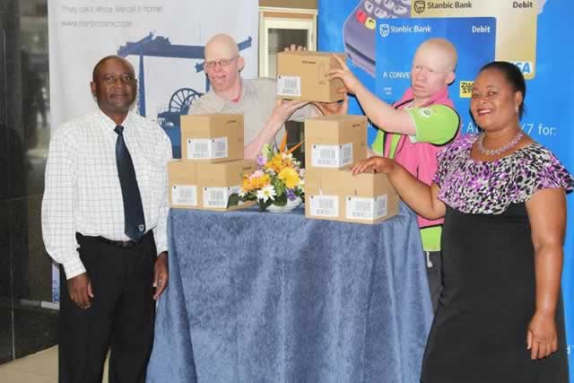 Stanbic Bank donates sunscreen lotion to albinos