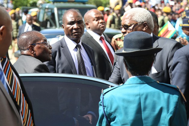 President Mugabe is welcomed by Home Affairs Minister Ignatius Chombo