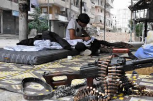 A rebel fighter cleans his weapon in the northern Syrian city of Aleppo on September 20, 2013. Syrian rebels have agreed a ceasefire with Al-Qaeda loyalists after bitter fighting for a key border town, a monitoring group said on Friday, as the opposition condemned the jihadist assault. – AFP.