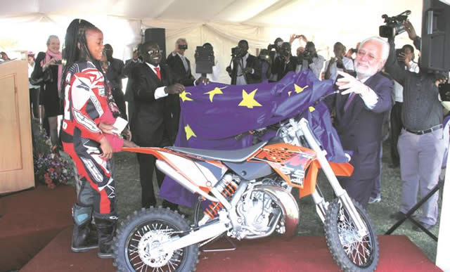 EARLY CHRISTMAS PRESENT . . . Female motocross rider Tanya Muzinda (left) cannot hide her excitement as she receives her brand new KTM motorbike from the outgoing European Union Ambassador to Zimbabwe, Aldo Dell’Arricia (right), at Donnybrook Raceway in Harare yesterday