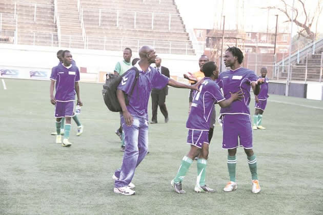 STOP THIS THUG . . . Mushowani coach Paul “Popopo” Chimalizeni (left) and his captain, Zivanai Mhanda (centre), prevent Tellmore Sasa from attacking the referee after yesterday’s match at Rufaro