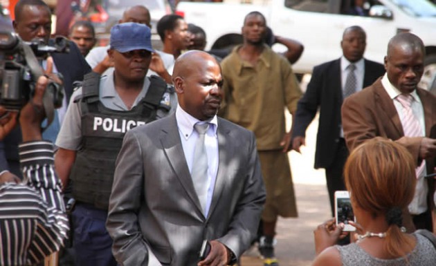 Prosecutor-General Johannes Tomana is escorted by detectives into the Harare Magistrates’ Courts on Monday under heavy police guard. —(Picture by Innocent Makawa)