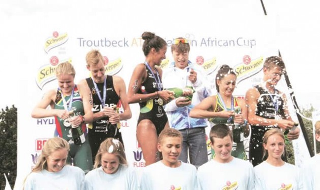 WINNERS PODIUM . . . Medalists in the elite men and women’s categories of the Schweppes Troutbeck ATU Triathlon Africa Cup pop the champagne in Nyanga — (Picture by Innocent Makawa)