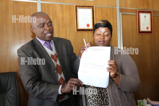 Tafadzwa Mapako holds the paternity results with her lawyer Gift Nyandoro