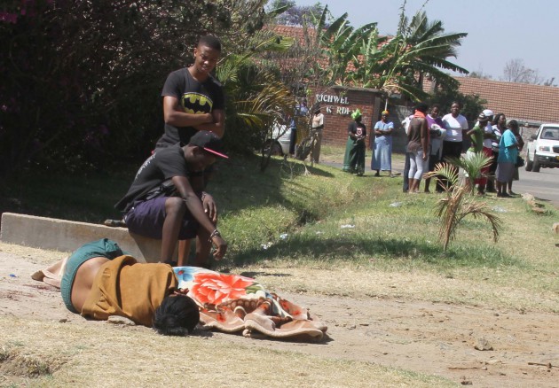 The daughter of the deceased lying next to the body
