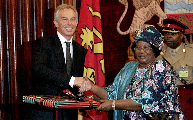 Caption: FLASHBACK ... President Joyce Banda presents a gift to former British premier Tony Blair at the Sanjika Palace in Blanytyre in 2012. - AFP.
