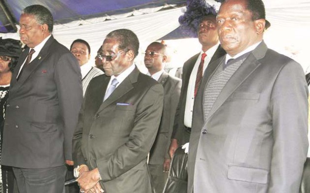President Mugabe flanked by his two Vice Presidents Cdes Emmerson Mnangagwa and Phelekezela Mphoko at the burial of Dr Charles Utete at the National Heroes Acre yesterday