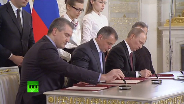 Russian President Vladimir Putin and representatives of Crimea sign the Unification Agreement in Moscow yesterday. — Russia Today