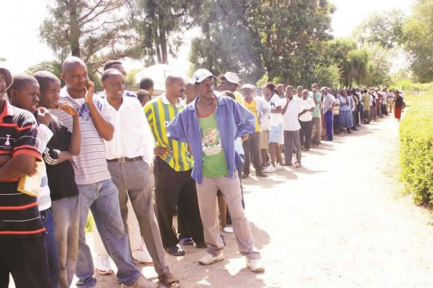 Voters wait to cast their vote in the 31 July 2013 harmonised elections