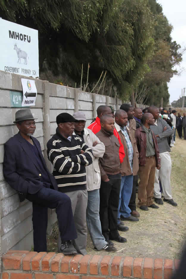 Voters queue outside Mhofu Primary School polling station where President Mugabe will also cast his ballot this morning