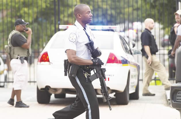 Police respond to the report of a shooting at the Navy Yard in Washington, DC, yesterday. At least one unidentified gunman opened fire at the US Navy Yard in Washington and was at large after killing “multiple” victims and wounding several more, officials said. Police and FBI agents descended on the area in force as helicopters swarmed overhead, amid reports a shooter was armed with an assault rifle and was holed up at the complex.— AFP