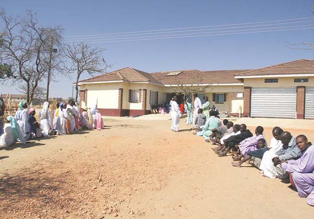 Johane Masowe Vadzidzi va Jeso congregants wait to be healed by Mudzidzi Wimbo at his homestead in Madziwa yesterday. — (Pictures by Tawanda Mudimu)