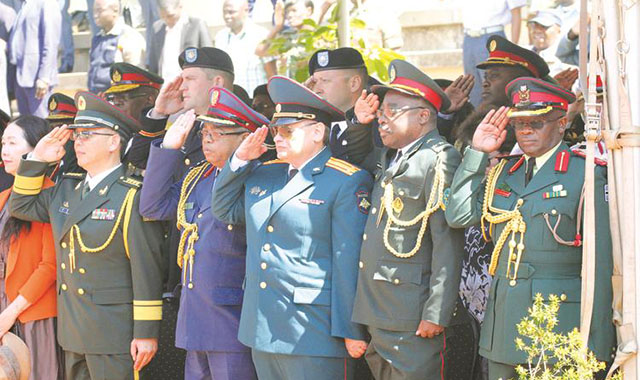Defence attachés salute during the singing of the National Anthem at Zimbabwe Defence Forces Day celebrations in Harare yesterday. — Picture by Innocent Makawa