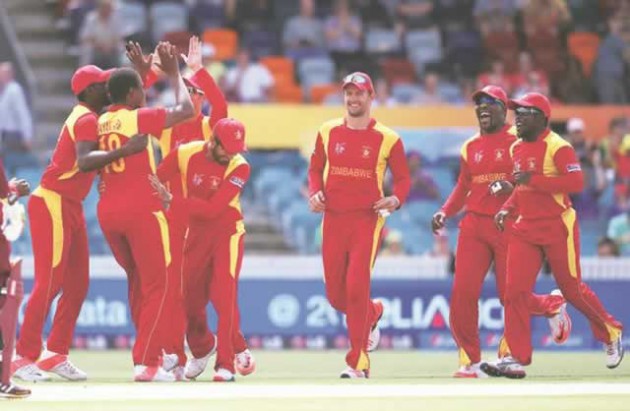 JOY BEFORE THE STORM . . . Zimbabwe seamer Tinashe Panyangara is mobbed by his teammates after striking in his first over to remove Dwayne Smith for a duck in yesterday’s World Cup tie against the West Indies. — Cricinfo