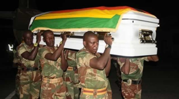 Pallbearers carry a casket bearing the body of national hero Brigadier-General John Zingoni at Manyame Airbase in Harare last night shortly after its arrival from Gweru. —(Picture by Innocent Makawa)