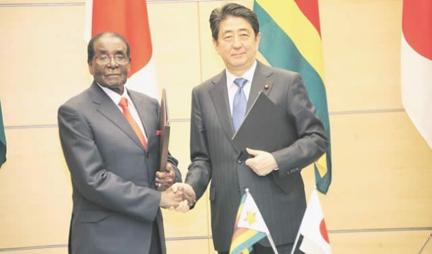 President Mugabe shakes hands with Japanese Prime Minister Shinzo Abe following a signing ceremony at the latter’s official residence in Tokyo, Japan yesterday. - Picture by Presidential Photographer Joseph Nyadzayo.
