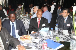 Industry and Commerce Minister Mike Bimha (left), Reserve Bank of Zimbabwe head of financial markets Mr Azvinandawa Saburi (centre) and Kasai Plascon chief executive Mr Nauman Malik follow proceedings during a  dinner to officially announce the acquisition of a 49 percent stake in Astra by Kasai on Wednesday