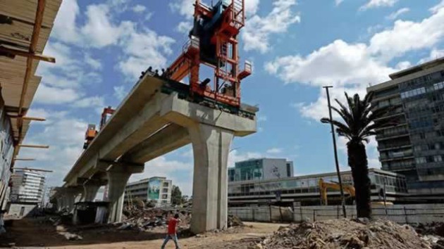A man walks past a portion of the Addis Ababa light railway under construction in Addis Ababa. The Addis Ababa Light Railway system contracted by the China Railway Group Limited will have a total of 41 stations