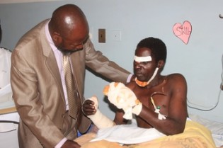 Buhera South legislator Cde Joseph Chinotimba chats with Ambi Dzere who was attacked by a hyena at Mutare General Hospital on Wednesday