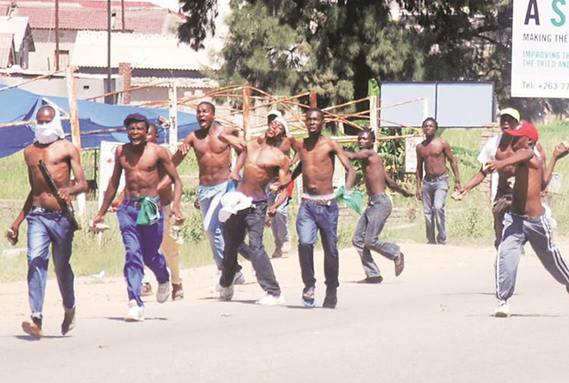 Rowdy youths and kombi crews patrol the streets of Chitungwiza, using catapults against the police. —(Pictures by Innocent Makawa and Lovemore Meya)