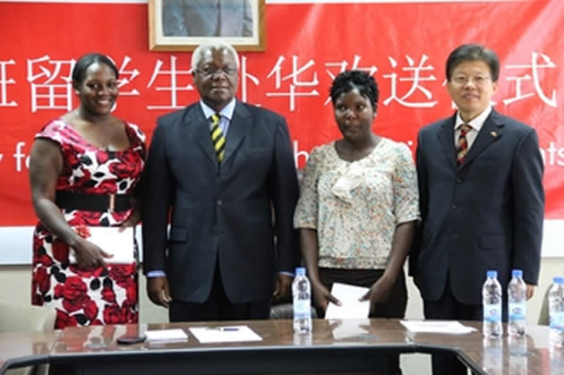 Local Government, Public Works and National Housing Minister Ignatius Chombo and Mr Han Bing with Snini Landa and Melody Rusinga, beneficiaries of Guoji University scholarships in Harare yesterday