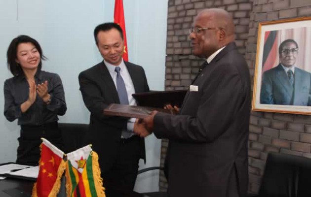 Information, Media and Broadcasting Services Minister Christopher Mushohwe (right) exchanges MoU files with Qingdao Hengshun Zhongsheng Group General Manager Brian He (centre) while Qingdao Hengshun Zhongsheng Group South Africa Administrative Director Shanel Liu looks on at Munhumutapa Offices yesterday