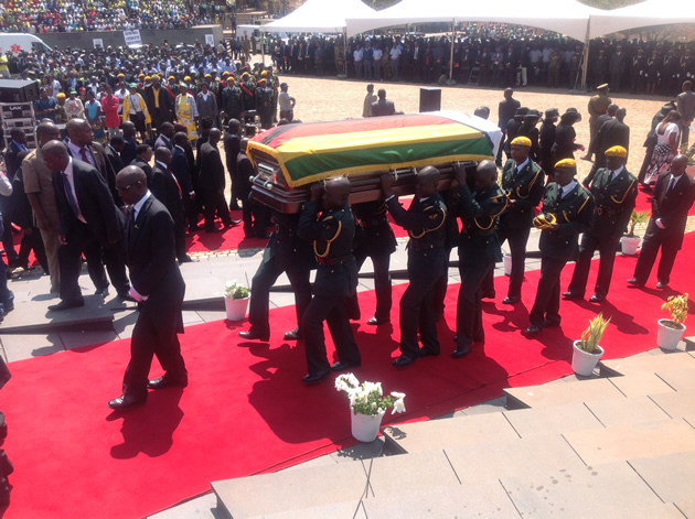 Pall bearers carry the body of Cde Nkala to the grave site (pic by Lloyd Gumbo)