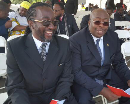 Youth Development, Indigenisation and Economic Empowerment Minister Cde Patrick Zhuwao chats to Minister of Local Government, Public Works and National Housing Cde Saviour Kasukuwere at the national shrine.