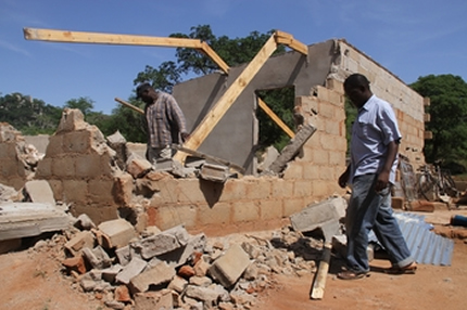 Headman Herbert Masunda (right) and his brother Tongai salvage bricks and other building material from their two-roomed house that was demolished following a dispute in Bikita recently. — (Picture by Munyaradzi Chamalimba)