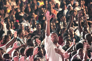 GLORY TO GOD . . . This picture combo shows Donnie McClurkin belting it out on stage and part of the crowd that turned up for the concert at the Glamis Arena on Saturday.