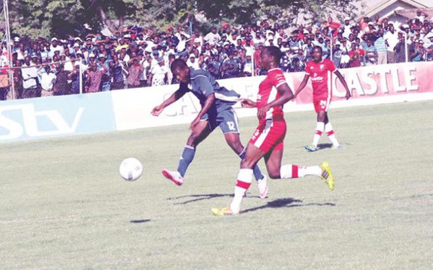 TUG OF WAR . . . Dynamos striker Quality Kangadze (left) shakes off the challenge of Triangle defender Donald Dzvinyai during yesterday‘s match at Gibbo. — (Picture by Paul Mundandi)