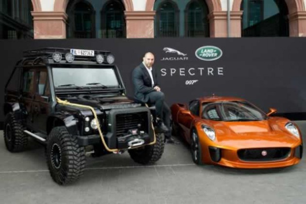 Dave Bautista, who plays henchman Mr Hinx, with the Land Rover Defender Bigfoot and Jaguar C-X75