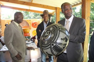 Information, Media and Broadcasting Services Minister Professor Jonathan Moyo holding tries his hand in mbira playing at the Mbira Centre in Harare yesterday. Picture By Ruvimbo Chakanyuka