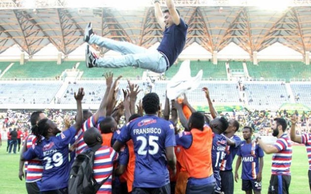 SWEET VICTORY . . . Fransisco Zekumbawire joins Bruce Kangwa and the rest of their teammates in throwing coach Boris Bunjak in the air after winning the Community Shield against Young Africans at the National Stadium in Dar es Salaam yesterday. — www.azamfc.co.tz