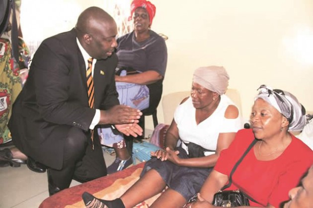 zanu-pf National Political Commissar Cde Saviour Kasukuwere consoles Mrs Gladys Kanengoni, (centre) wife of war veteran and writer Cde Alexander Kanengoni and sister Nancy Chimanzi (right) at their family home in Harare’s Warren Park D suburb yesterday. — Picture by Memory Mangombe