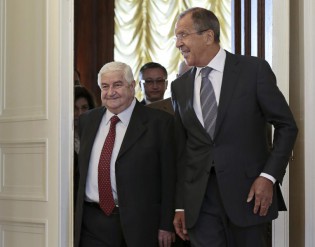 Russian Foreign Minister Sergey Lavrov welcomes his Syrian counterpart Walid al-Moallem, left, prior to talks in Moscow on Monday, Sept. 9, 2013-. (AP Photo/Ivan Sekretarev)