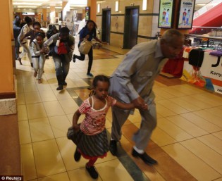 Escape: Women carrying children run for safety after al Shabaab terrorists stormed Westgate shopping center in Nairobi, Kenya armed with guns and grenades