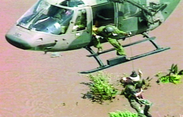  A South African sergeant reaches out for his winchman while holding baby Rosita