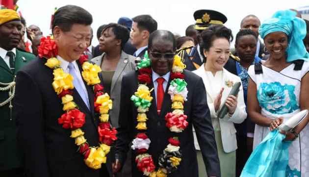 President Mugabe and his Chinese counterpart President Xi Jinping salute multitudes of people who thronged Harare International Airport to welcome the latter. With them are First Ladies Amai Grace Mugabe and Peng Liyuan — (Picture by Believe Nyakudjara)