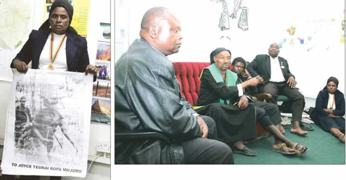 Left: Cde Linda Mangwende holds the poster with her portrait bearing Vice President Joice Mujuru`s name in Harare yesterday; Above: From left, Cde Rynos Mutodi, Tateguru Basvi Kuda Chikosha, Cde Joshua Kativhu and Cde Linda Mangwende, known as Cde Sarudzai Nehanda, listen to Tenzi Nehoreka (in gown) speaking in Harare yesterday
