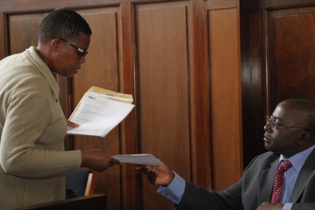  Sabena Ranganai Chitema (L) files Didymus Mutasa's nomination papers to Manicaland provincial elections officer Mr Moffat Masabeya