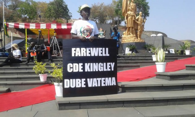 A mourner holds a banner at the national shrine.