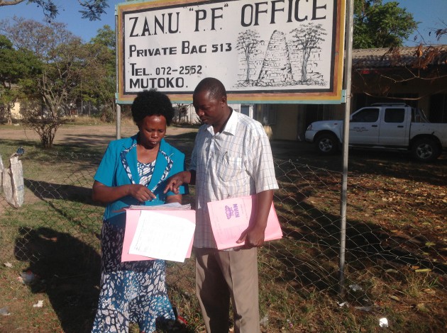 National Assembly Member for Mutoko Cde Getrude Hungwa Mariwo and Staff member at party district offices Cde Nyika Kambanje verify registers to be used when voting starts