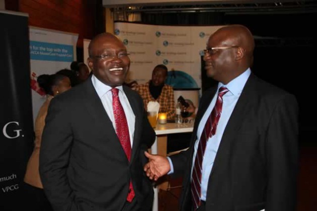 FBC Chairman Herbert Nkala (right) shares a lighter moment with former ABC Holdings chief executive Doug Munatsi at the launch of the Central African Stock Exchanges handbook on Wednesday