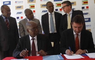 NMB Bank managing director Mr Benefit Washaya (seated left) and Propaco regional representative for Southern Africa, Mauritius and Madagascar Mr Christophe Blanchot sign the agreement for a US$10 million line of credit to NMB yesterday while French Ambassador to Zimbabwe Laurent Delahouse (standing right) discusses with NMBZ Holdings chief executive James Mushore (second right), Foreign Affairs Deputy Minister Ambassador Christopher Mutsvangwa and Harare mayor Bernard Manyenyeni (left)