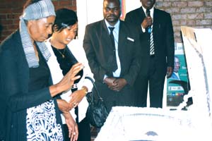 farewell . . . Mrs Shamiso Nyashanu (left), the widow of Cde Nevison Mukanganga Nyashanu, and Mrs Winnie Murefu during the body viewing session. [Pictures by Kudakwashe Hunda.