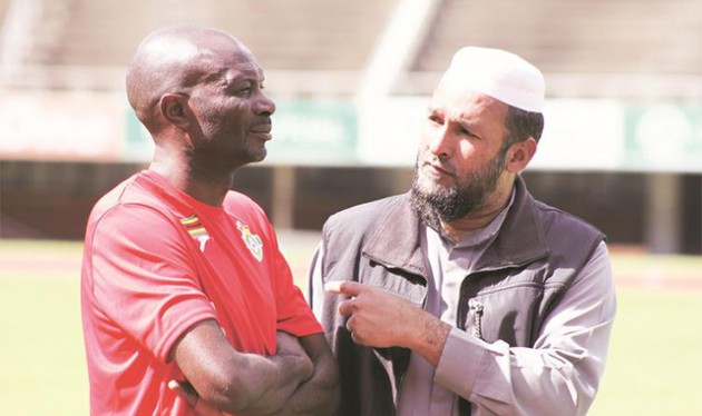 FOR OUR NATION . . . Warriors team manager Shariff Mussa (right) discusses a point with head coach Callisto Pasuwa during the senior national team’s training session at the National Sports Stadium yesterday